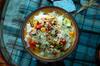 Mediterranean-inspired meal of tomatoes, sweet bell peppers, zucchini, and pine nuts with garden herbs on rice.