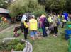 next photo: volunteers mingle in the garden