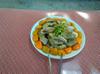 Cooked chicken garnished with onions and encircled with persimmons
