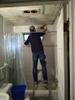 Christiopher cleaning out mold in back bathroom
