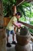 next photo: Qian cracking open glutinous rice cooked in bamboo 竹筒飯